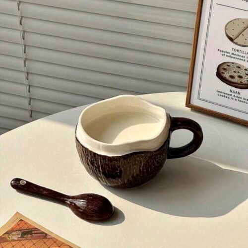 Coconut-inspired ceramic mug with brown textured exterior, white interior, and matching brown spoon, dishwasher & microwave safe