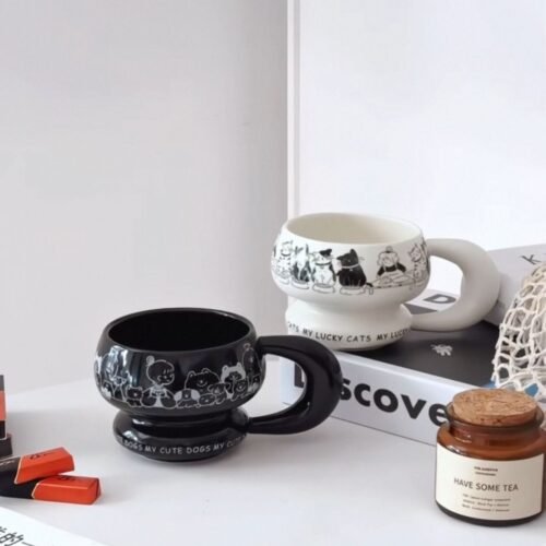 Round sculptural ceramic mug with chunky circular handle, thick rounded rim and base, available in black or white with dog or cat print