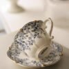 White ceramic cup and saucer with blue floral prints and subtle gold accents, dishwasher & microwave safe, inspired by antique royal tea cups