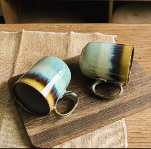 Ceramic mug with stone-look finish in green, brown, and blue tones, smooth interior, cozy rounded handle, dishwasher and microwave safe