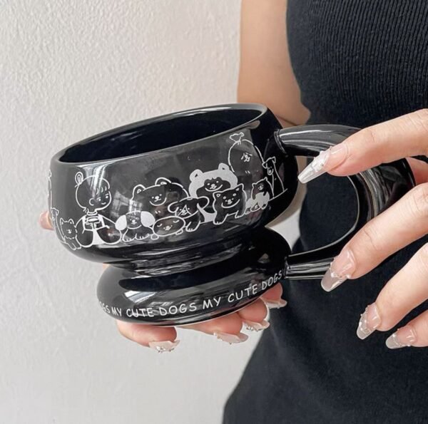Round sculptural ceramic mug with chunky circular handle, thick rounded rim and base, available in black or white with dog or cat print