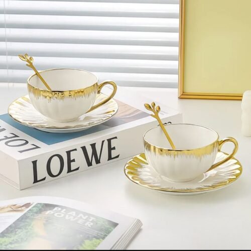 Elegant white ceramic cup and saucer set with gold rim accents, classic design, dishwasher and microwave safe