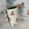 White oval ceramic mug with cherry blossom design, can be used as a vase or for tea and coffee