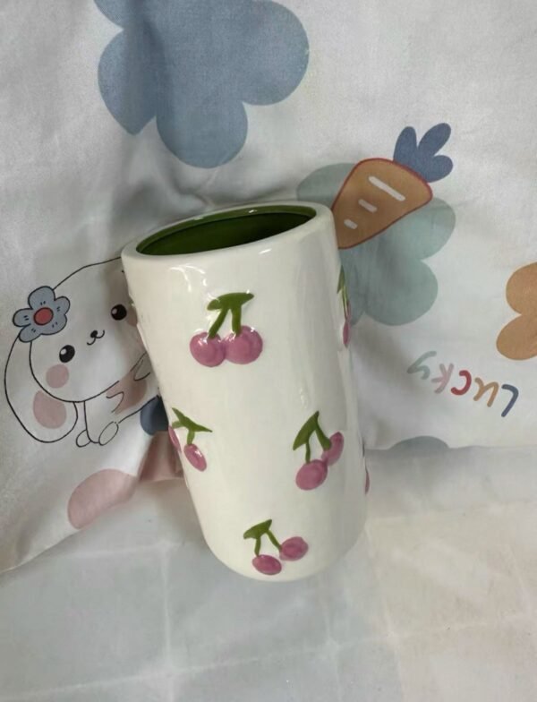White oval ceramic mug with cherry blossom design, can be used as a vase or for tea and coffee