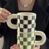 Ceramic checkered mug with rounded handle, 300ml capacity, chessboard-inspired design, dishwasher and microwave safe